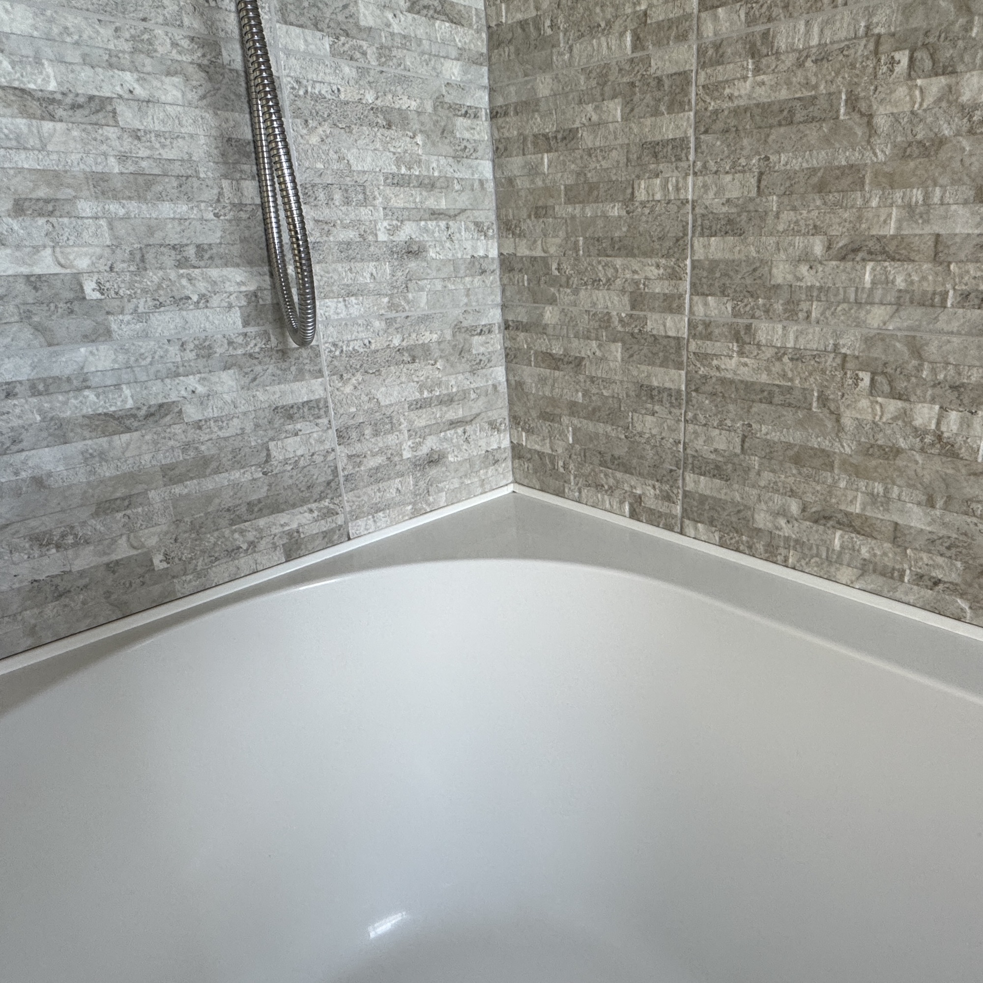 bath with stone look tiles