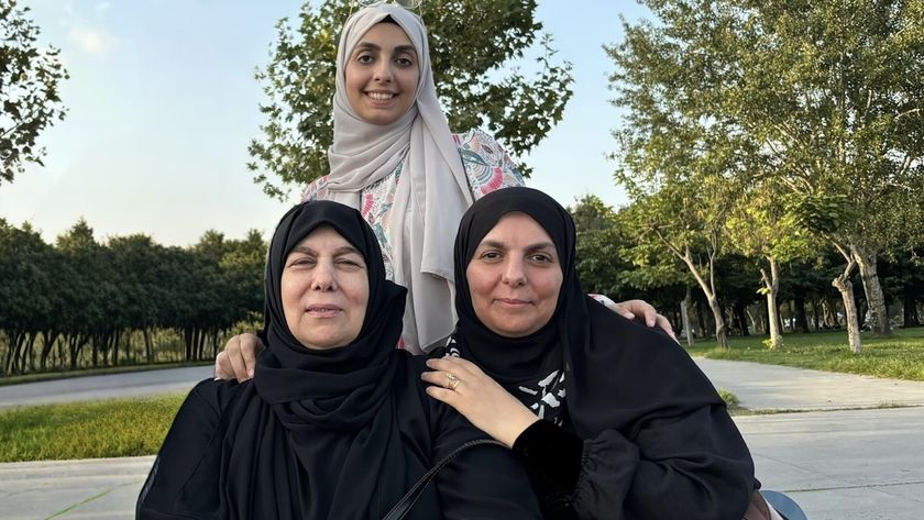 A group of three women of different generations wearing head coverings