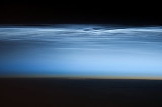 An photograph of night-shining clouds taken with a Nikon D3S digital camera using a 400 millimeter lens by an astronaut aboard the ISS on January 5, 2013.