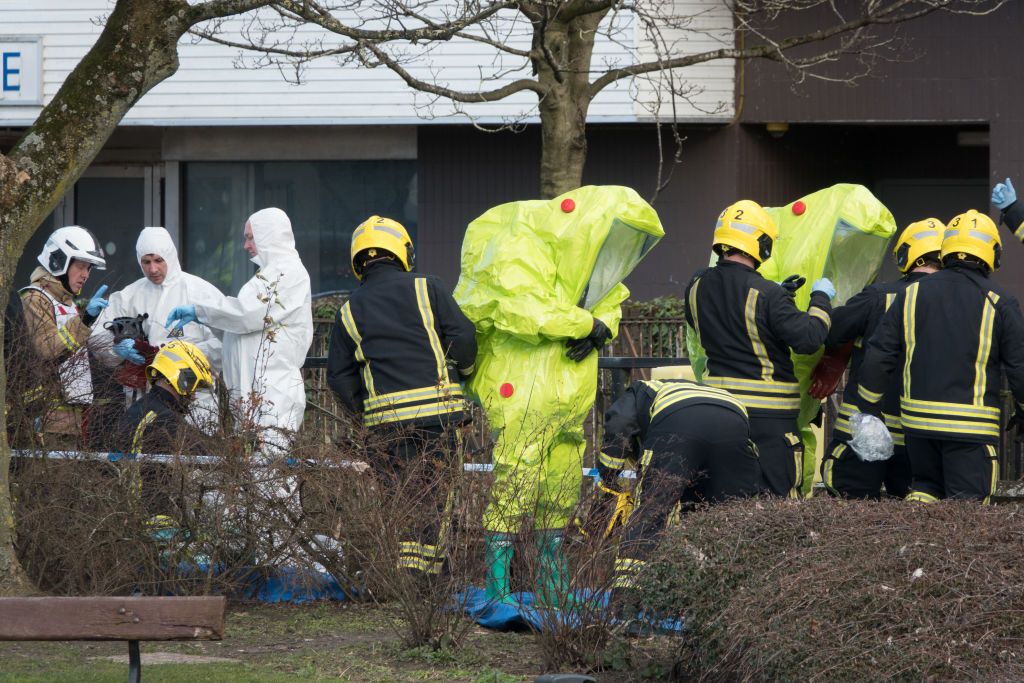 Authorities wear protective wear in Salisbury, England.