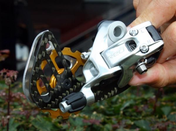 The top SRAM-equipped GC riders in this year's Tour de France are using these special Red rear derailleurs, retrofitted with Berner large-diameter pulleys and cages that supposedly decrease drivetrain drag.