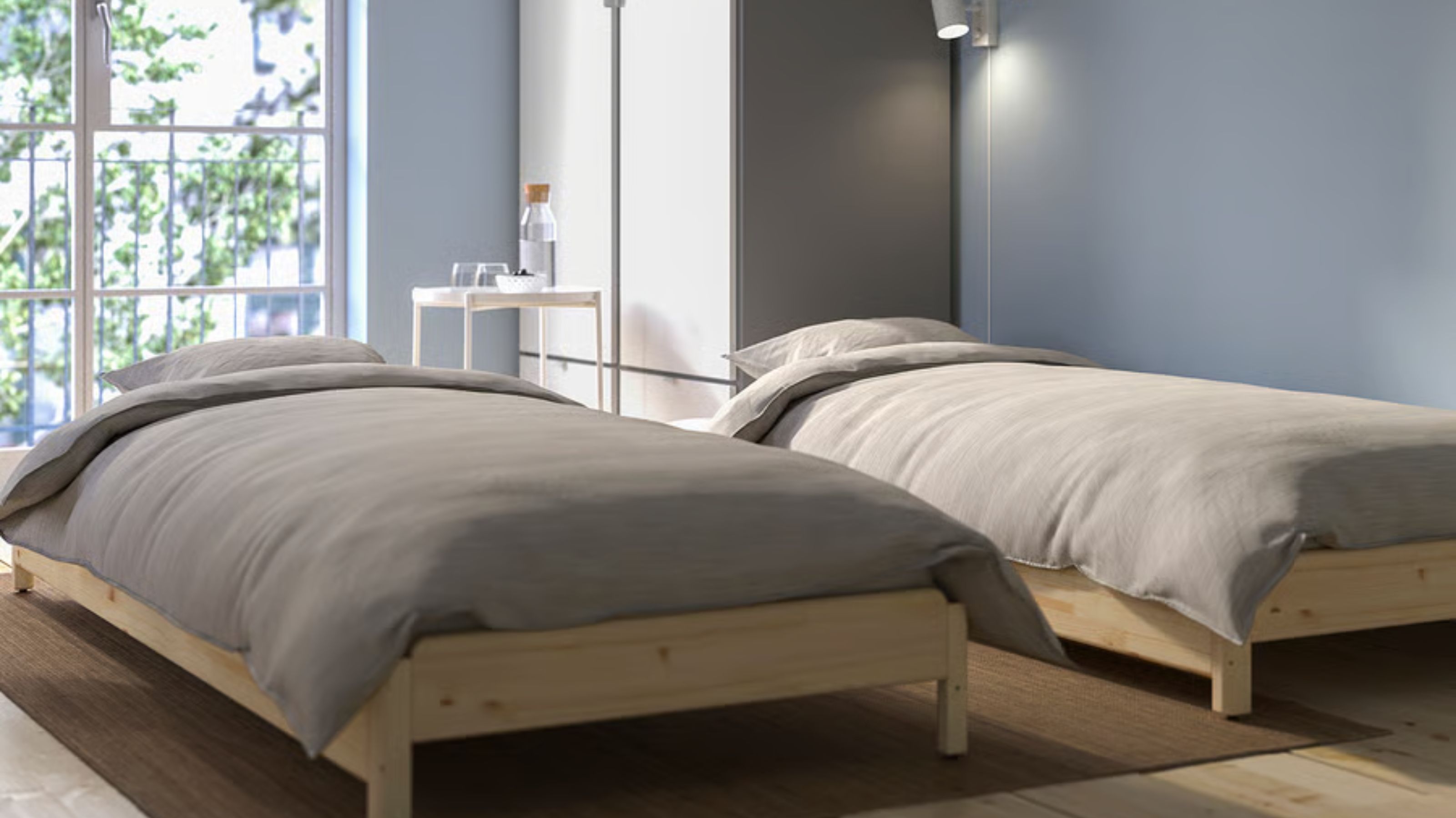two stackable beds from IKEA in a guest bedroom with a door out to a balcony