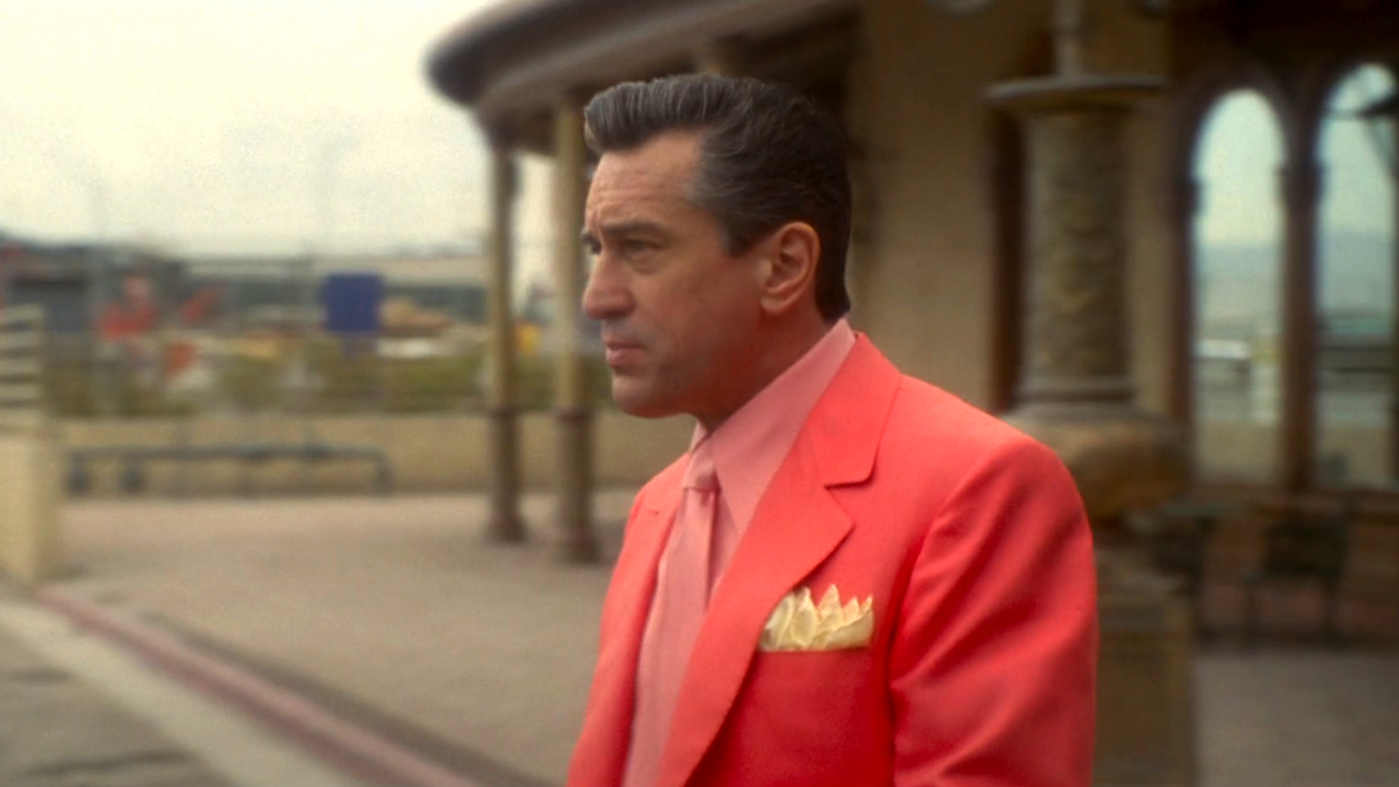 Robert DeNiro walking to the parking lot in a pink suit in Casino.