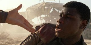 Finn taking Rey's hand in The Force Awakens