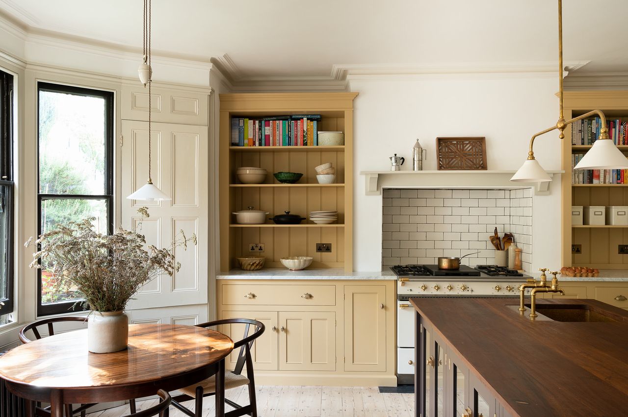 Pale yellow kitchen by deVOL