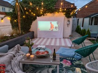 an outdoor projector set up in a garden