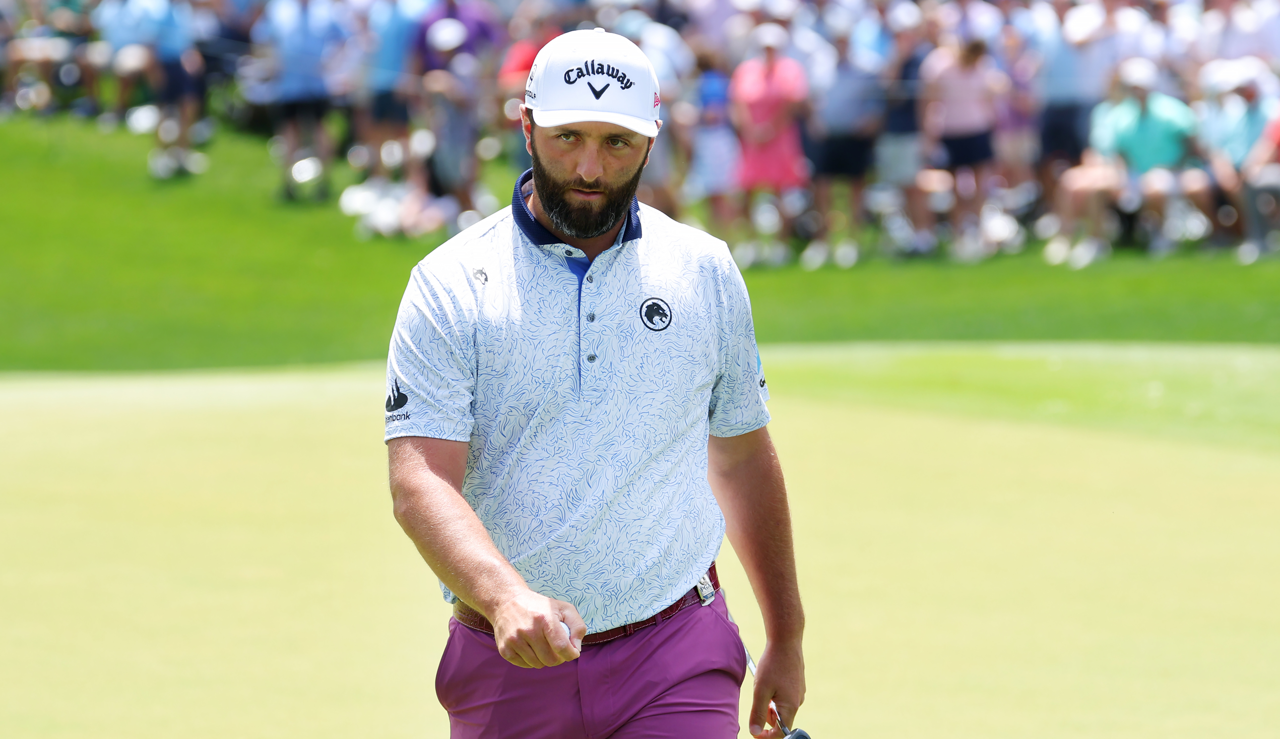 Jon Rahm walks off the green