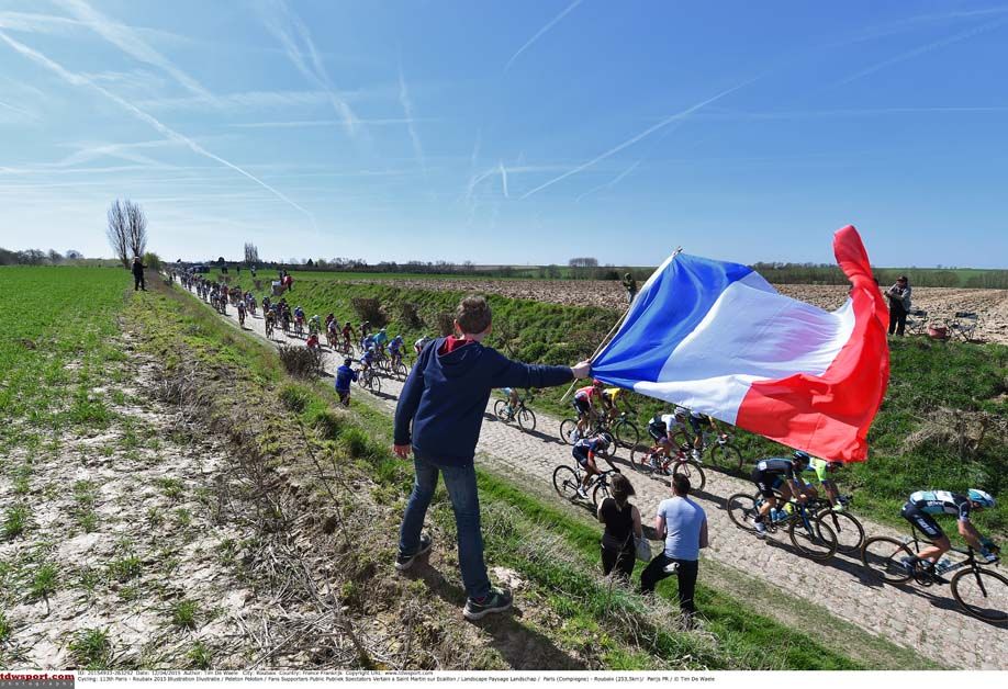 A fan waves a French flag during Paris-Roubaix