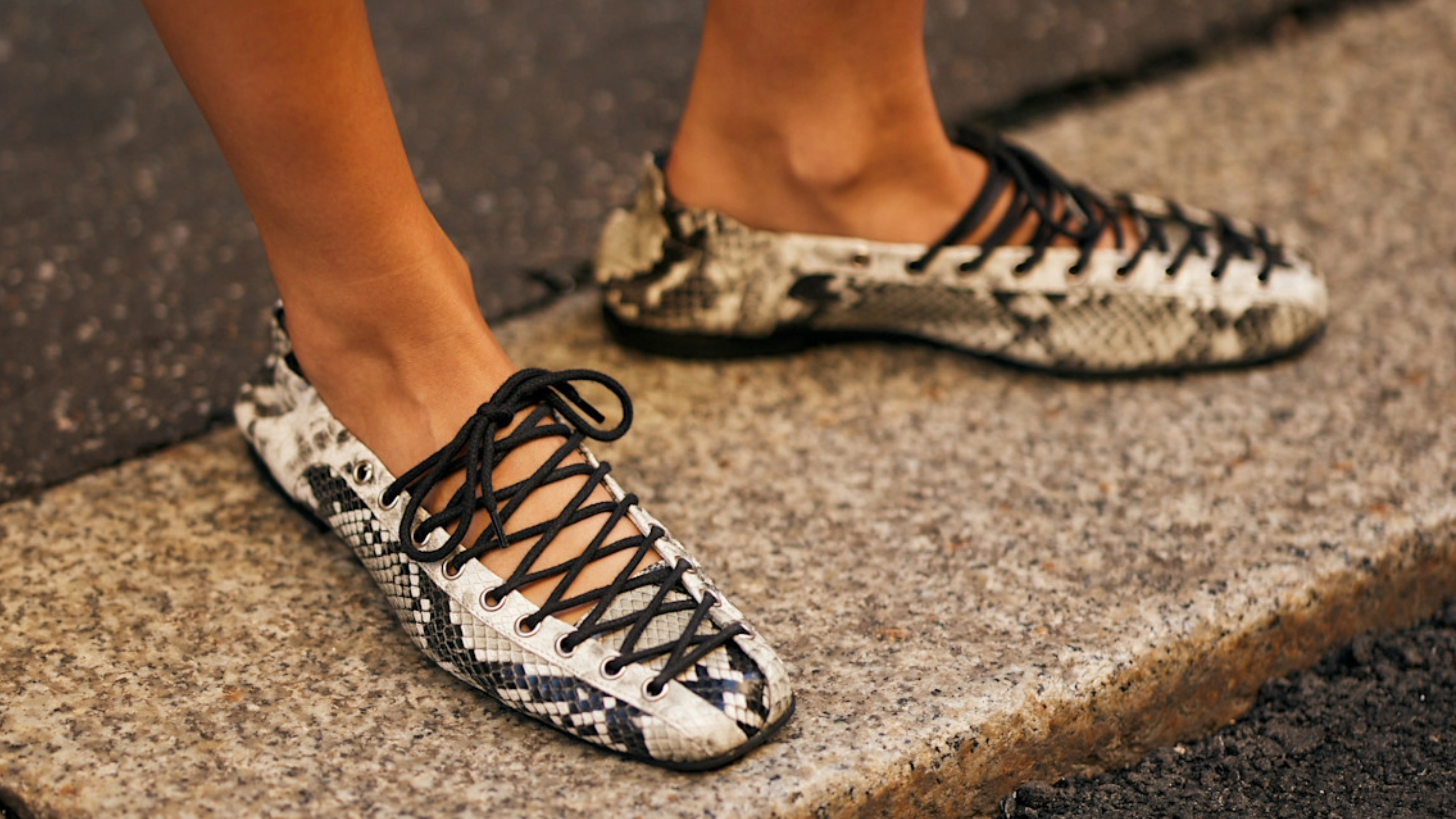 woman wearing a pair of snakeskin flats 