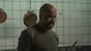 Isaac standing in front of pans during torture sequence in The Last of Us Season 2 "Day One"