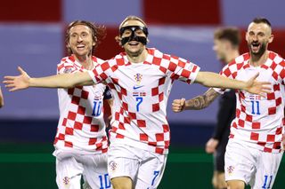 Lovro Majer of Croatia celebrates with teammates Luka Modric and Marcelo Brozovic after scoring their side's second goal during the UEFA Nations League League A Group 1 match between Croatia and Denmark at Stadion Maksimir on September 22, 2022 in Zagreb, Croatia.