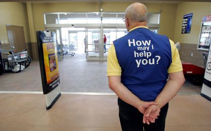 BOWLING GREEN, OH - MAY 17:A Wal-Mart greeter waits to welcome new customers to the new 2,000 square foot Wal-Mart Supercenter store May 17, 2006 in Bowling Green, Ohio. The new store, one of