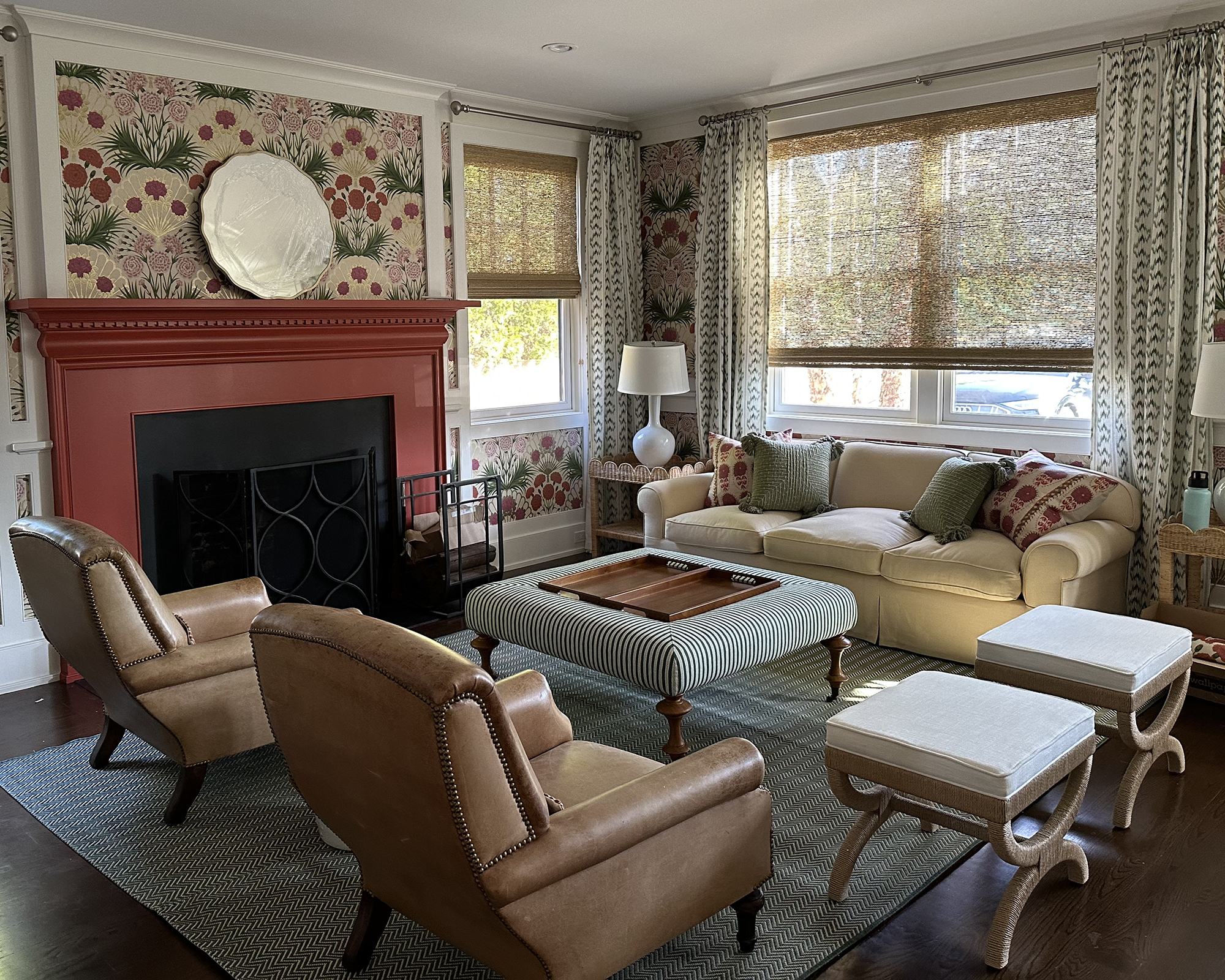living room with red fireplace and brown chairs