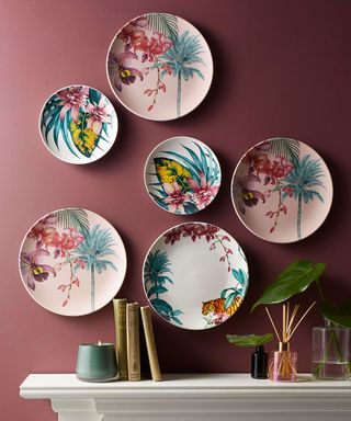 dining room with pink wall and floral plates