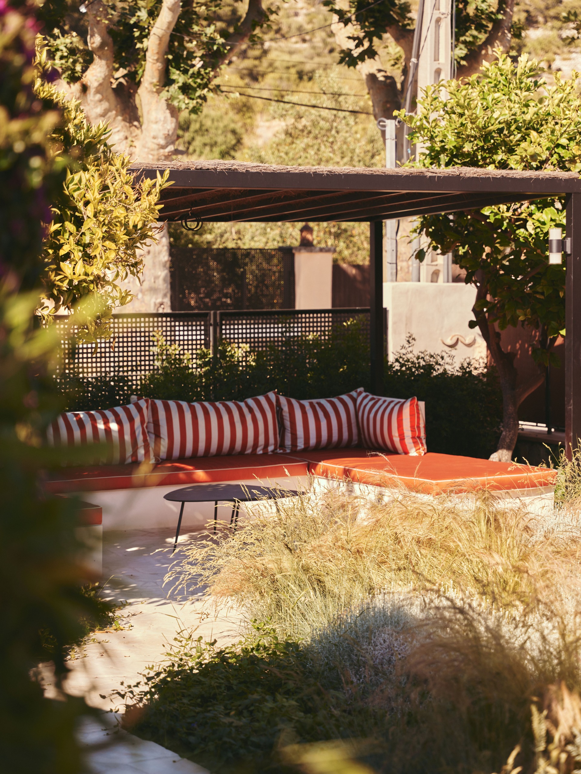 outdoor seating area under cover with red striped cushions