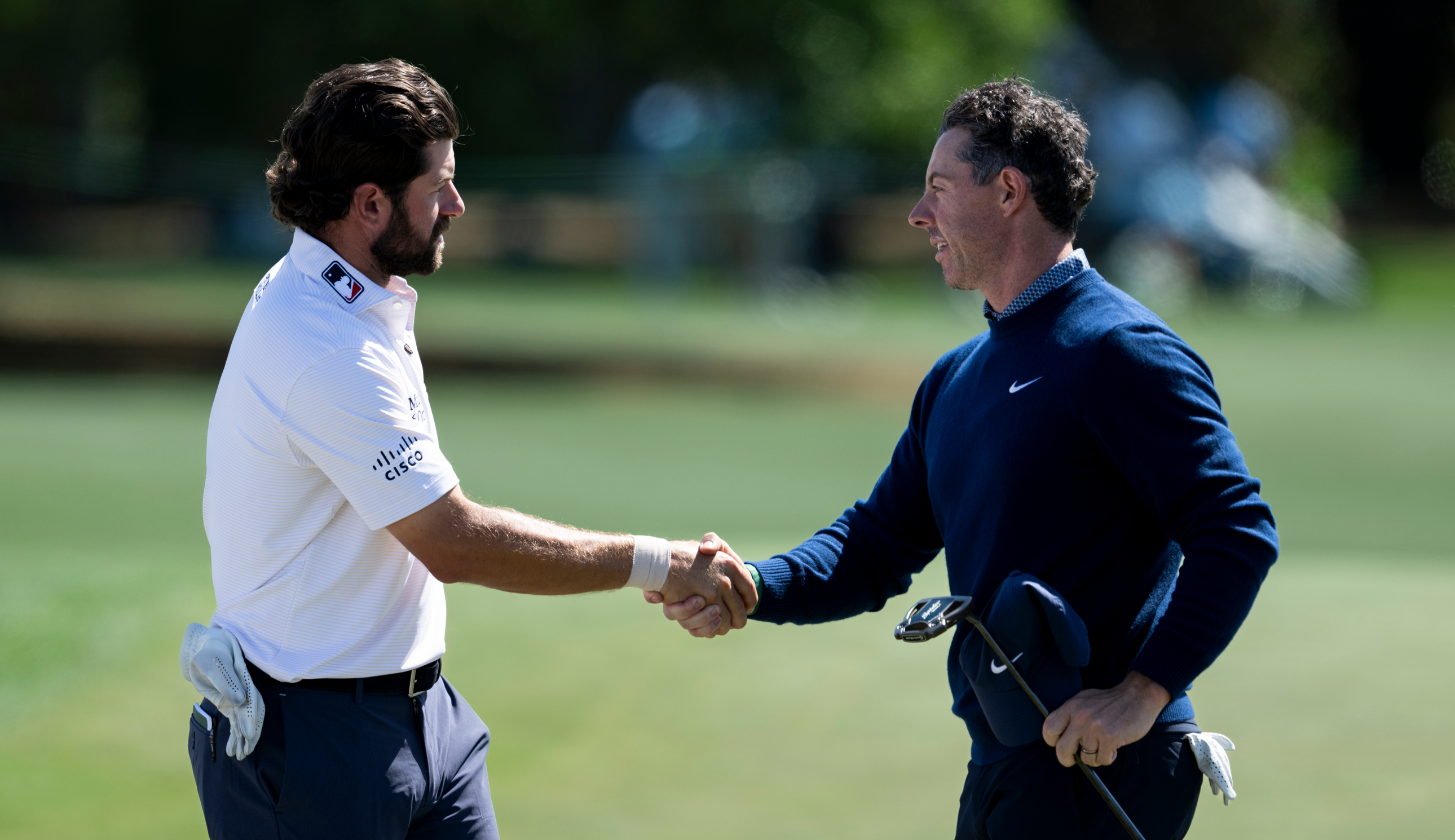 Cameron Young and Rory McIlroy shake hands