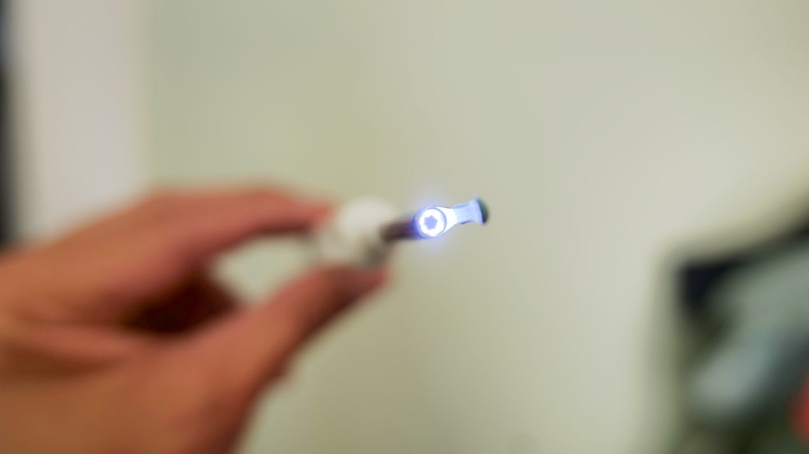 Xlife wireless endoscope camera being used to remove ear wax in ear.