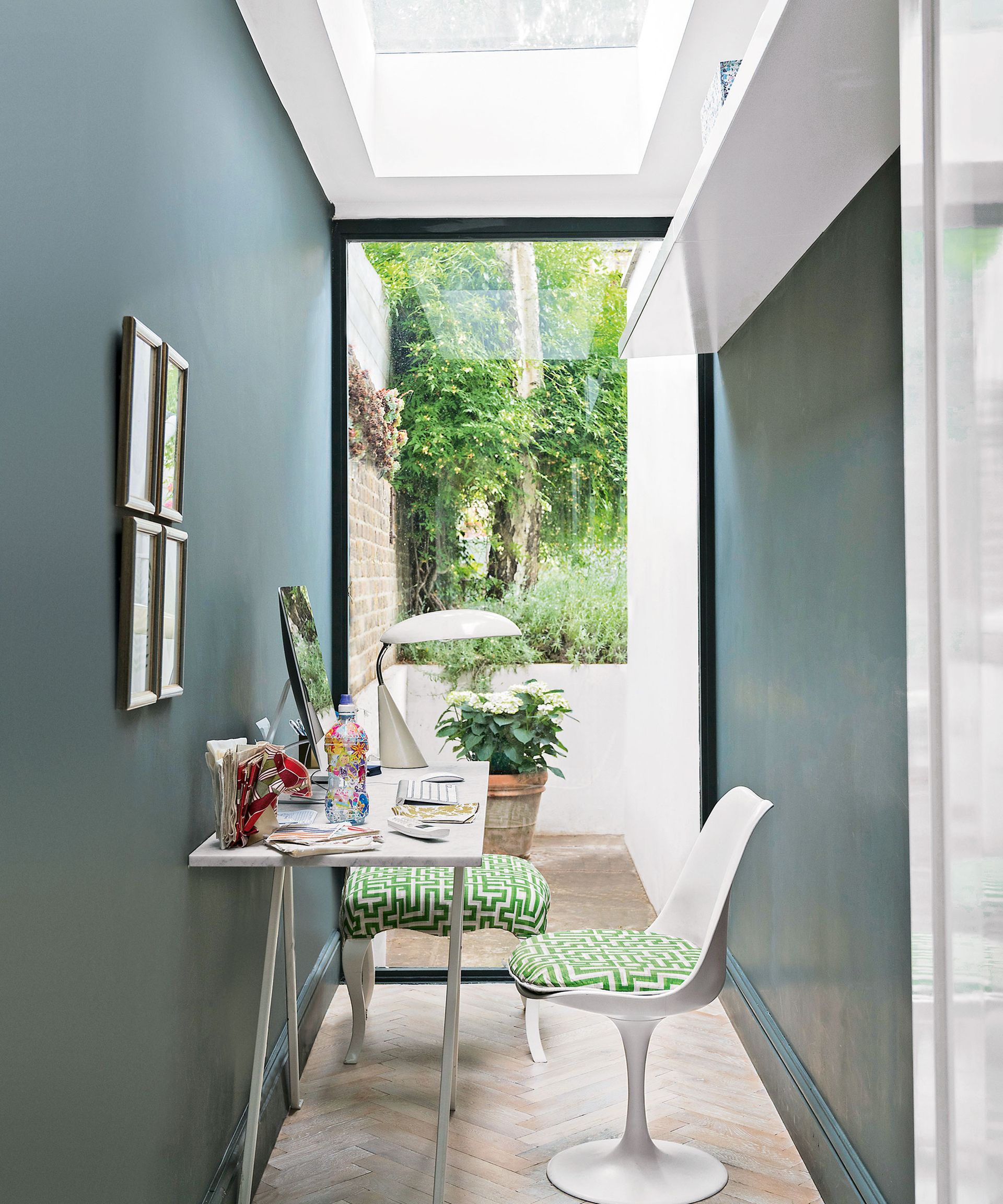 desk in narrow home office with picture window