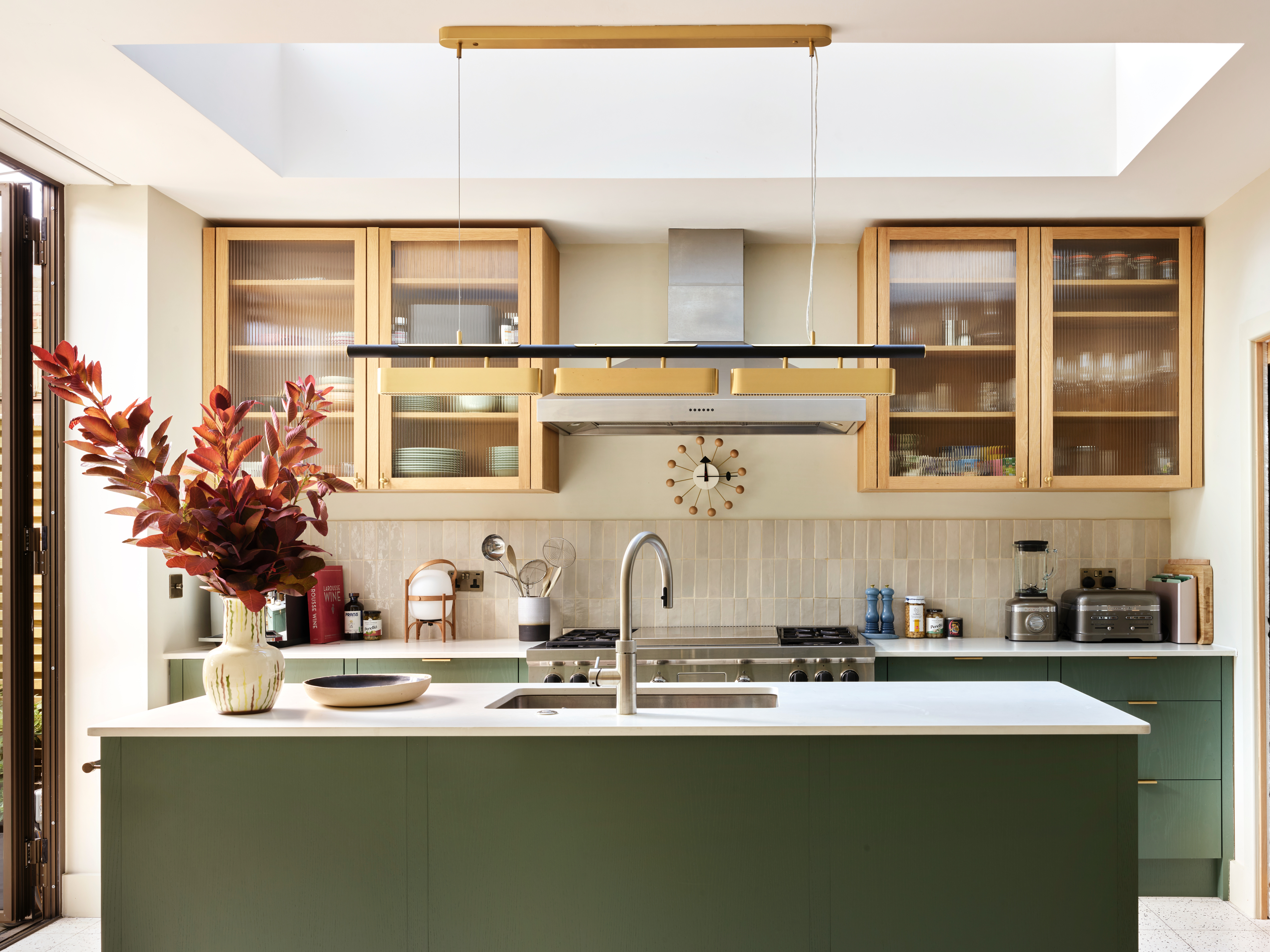Olive green kitchen extension with brass details