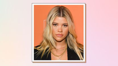 Sofia Richie pictured against an orange backdrop as she attends The Kate Somerville Clinic's 15th Anniversary Party at The Kate Somerville Clinic on October 10, 2019 in Los Angeles, California./ in a cream and pink template