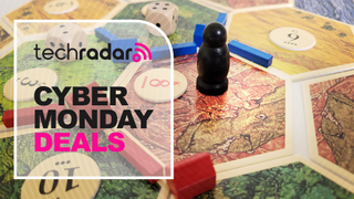 Catan being played next to a Cyber Monday deals banner