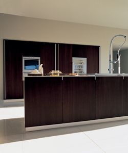 walnut kitchen with integrated doors with built in handles that fit into the worktops