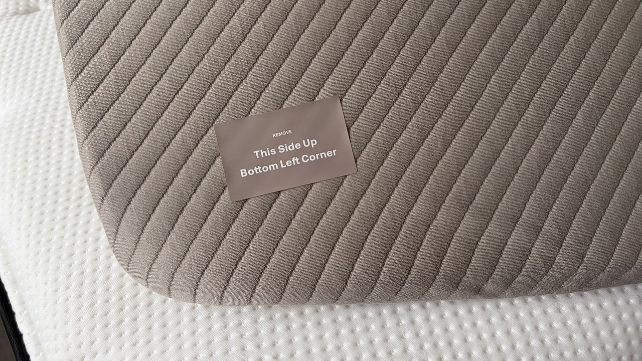 A close up of the Orion mattress cover with a sticker saying 'This Side Up'