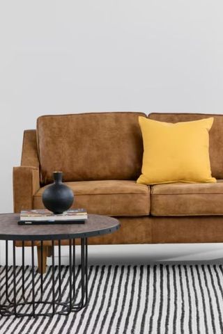 Made.com sofa in brown tan on patterned rug with cushion 