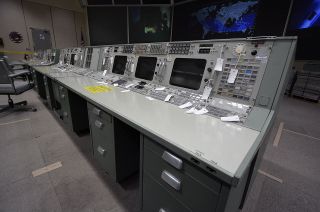 Inside Mission Operations Control Room-2 at NASA's Johnson Space Center in Houston, the Apollo-era consoles have been prepared for their move to the Cosmosphere in Hutchinson, Kansas. Every component was inventoried and tagged by serial number and console position.