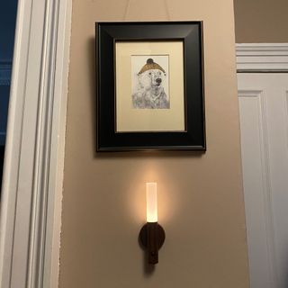 hallway wall light beside a framed print