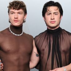 Hudson Williams and Connor Storrie coordinated at the 2026 Vanity Fair Oscar Party in matching naked shirts