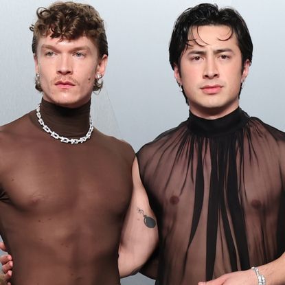 Hudson Williams and Connor Storrie coordinated at the 2026 Vanity Fair Oscar Party in matching naked shirts