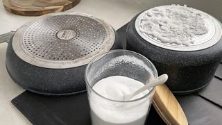 Baking soda being used to clean the base of pots and pans