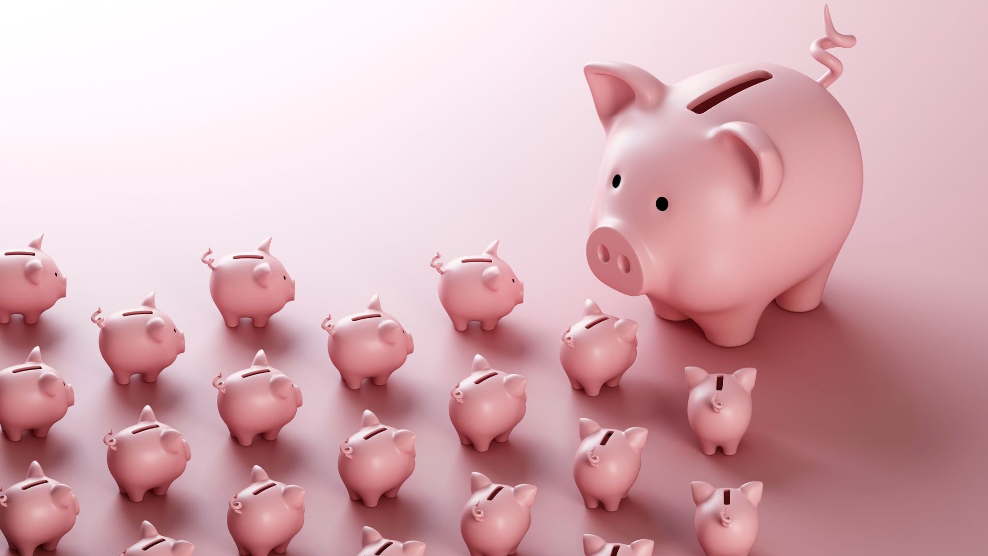 Large piggy bank surrounded by smaller piggy banks 