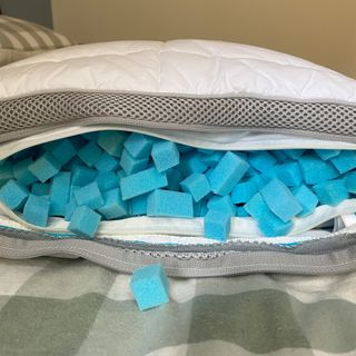 The Simba Hybrid pillow unzipped to show the blue foam cubes inside it