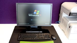 A desktop computer with the Microsoft Windows XP operating system loading on its screen.