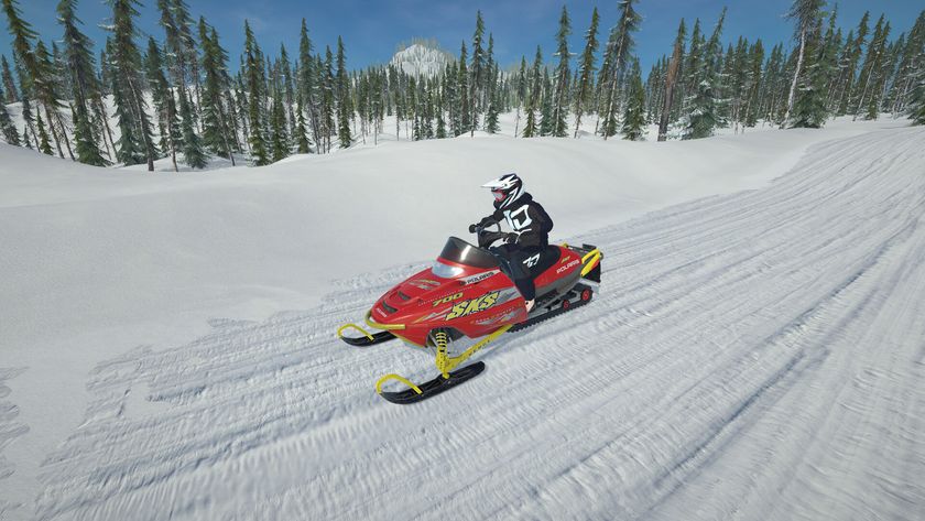 A person on a snowmobile riding a track in the forest in game Sledders.