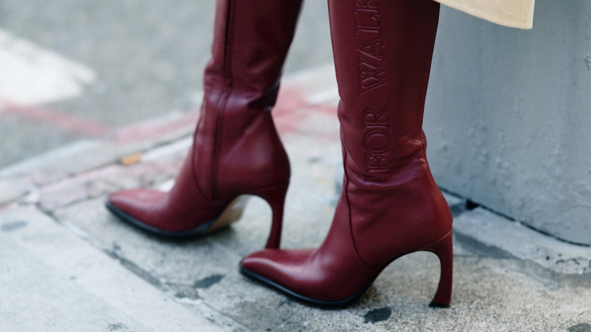 woman wearing burgundy boots in new york