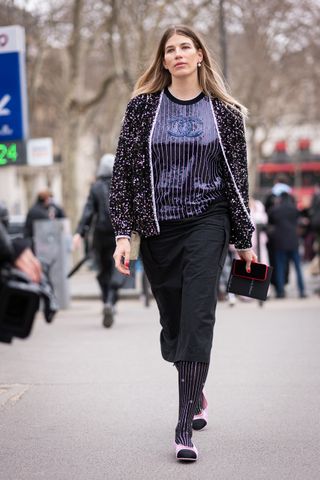 a woman wears cap-toe shoes in Paris