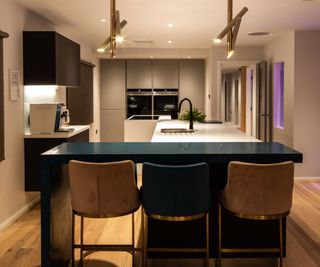 View of contemporary kitchen diner with different lighting temperatures