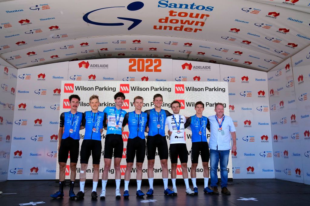 WILLUNGA HILL AUSTRALIA JANUARY 29 A general view of Drew Morey of Australia Sam Jenner of Australia James Whelan of Australia blue Santos leaders jersey Alistair ChristieJohnson of Australia Nick White of Australia Matt Dinham of Australia white best young rider jersey and JeanPierre Van Der Merwe of Australia and Team Bridgelane pose on the final podium ceremony as best team after the 2nd Santos Festival Of Cycling 2022 Mens Elite Stage 3 a 1132km stage from McLaren Vale to Willunga Hill 224m TourDownUnder on January 29 2022 in Willunga Hill Australia Photo by Daniel KaliszGetty Images