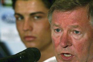 Cristiano Ronaldo as Sir Alex Ferguson speaks at a Manchester United press conference in 2005.