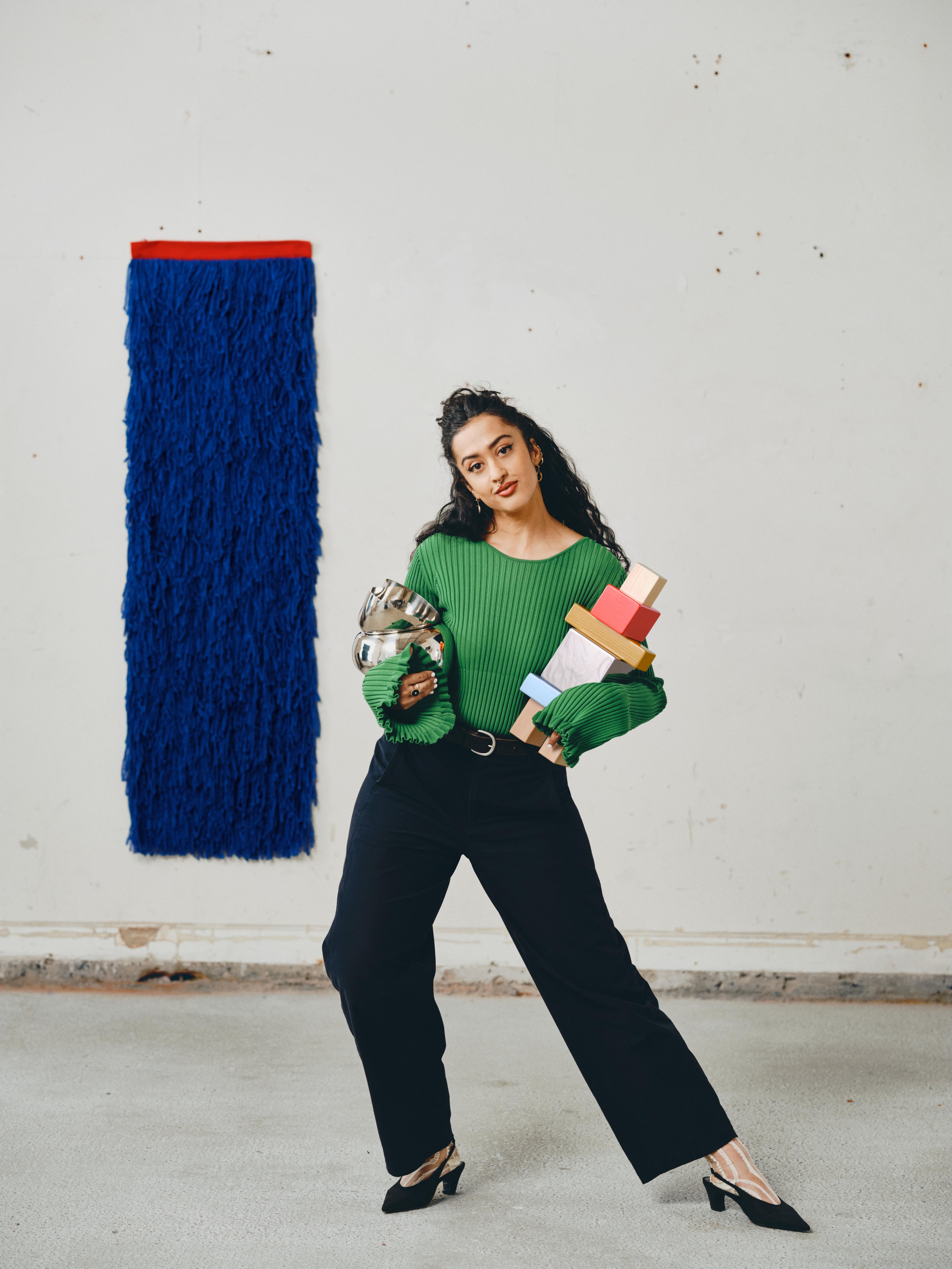 Akanksha Deo poses with her decorative objects and wall hanging