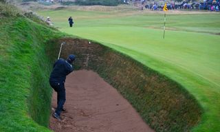 Daniel Brown hits a bunker shot