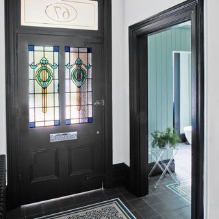 black glass door with table and door mat