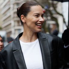 Adriana Lima wears a leather blazer