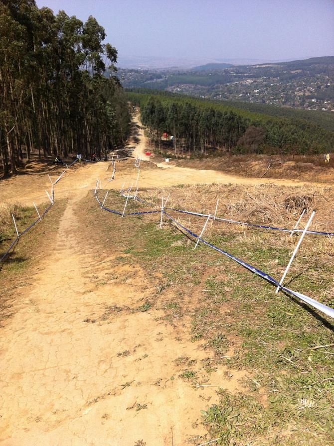 A long straight, pedalling section on the downhill course, with a view of Pietermaritzburg.