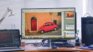 BenQ PD3220U on messy desk