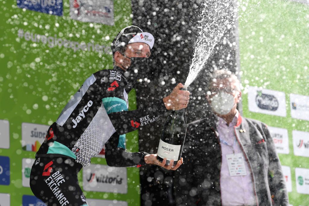 FEICHTEN IM KAUNERTAL AUSTRIA APRIL 20 Simon Yates of United Kingdom and Team BikeExchange celebrates at podium during the 44th Tour of the Alps 2021 Stage 2 a 1215km stage from Innsbruck to Feichten im Kaunertal 1291m Champagne Mask Covid Safety Measures TourofTheAlps TouroftheAlps on April 20 2021 in Feichten im Kaunertal Austria Photo by Tim de WaeleGetty Images