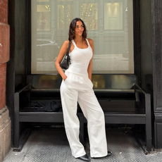 woman wearing all-white outfit and black accessories
